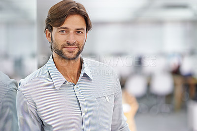 Buy stock photo Portrait of a handsome young businessman standing in his office