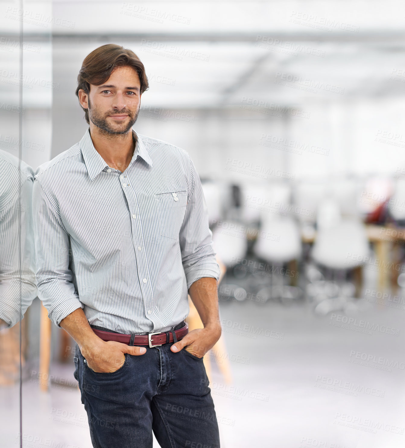 Buy stock photo Portrait of a handsome young businessman standing in his office