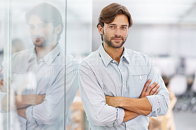 Buy stock photo Portrait of a handsome young businessman standing in his office