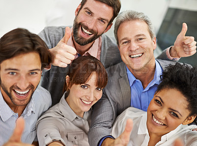Buy stock photo Portrait of a group of businesspeople giving the thumbs up to the camera