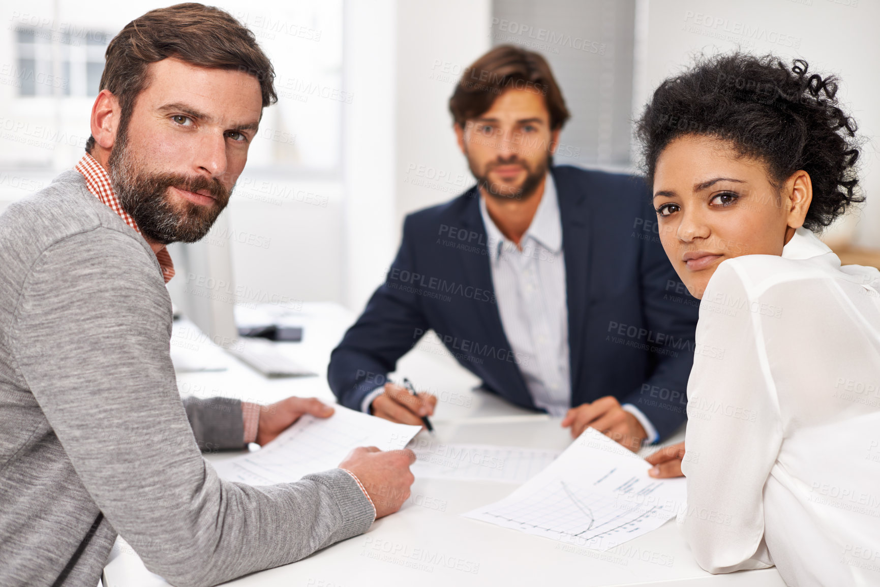 Buy stock photo Portrait of a group of young office professionals going over paperwork