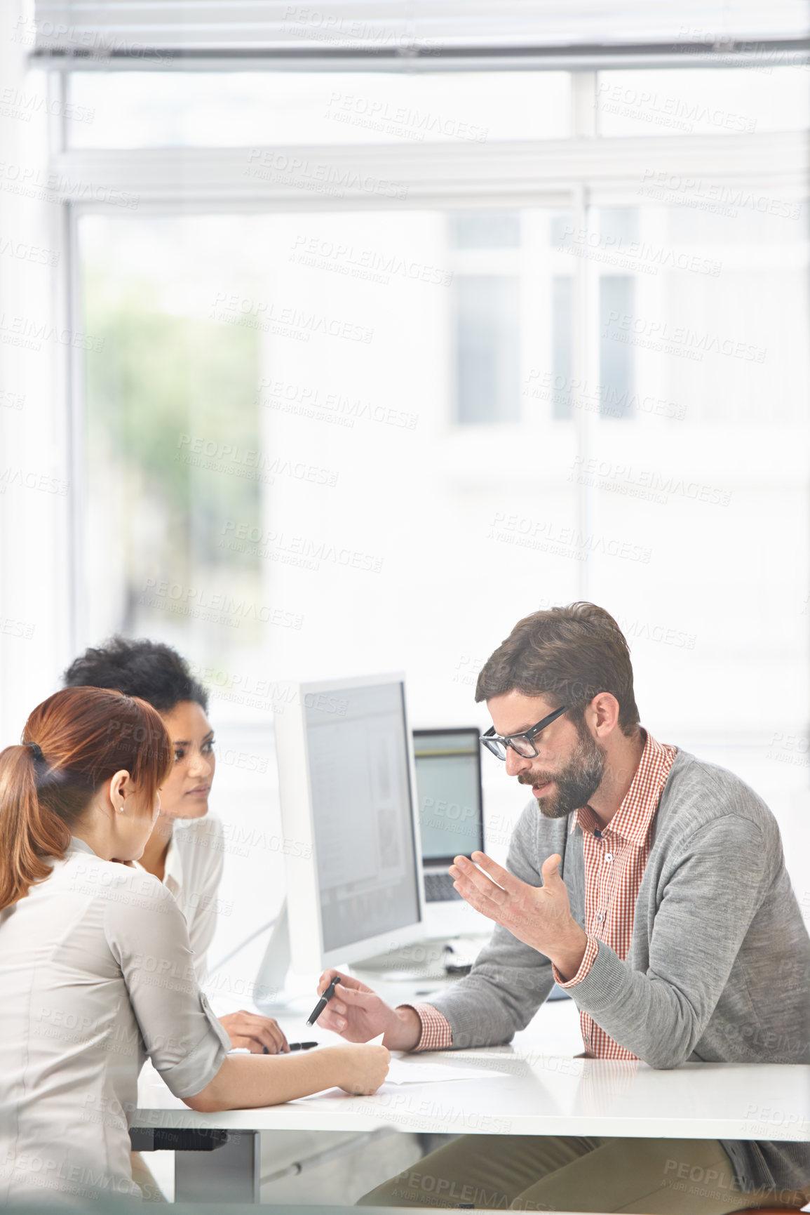 Buy stock photo A group of businesspeople going over some plans together