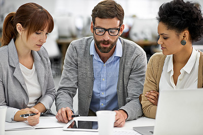 Buy stock photo Businessman, tablet and meeting with team in research, planning or brainstorming at office. Business people, group or employees with technology or notebook in project plan or development at workplace