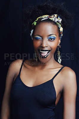 Buy stock photo African woman, wink and studio for makeup, style and smile for eye shadow and glamour. Black female model, dark background and cosmetic, portrait and face for cultural, fashion and elegant earrings