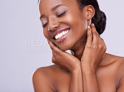 Buy stock photo A beautiful young woman pampering herself in the studio