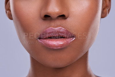 Buy stock photo Cropped shot of a young woman's mouth against a purple background