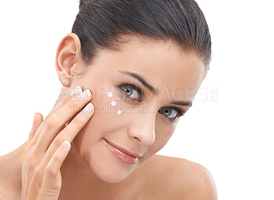 Buy stock photo Happy woman, portrait and skincare with face cream, lotion or cosmetics on a white studio background. Face of female person, brunette or model applying creme or moisturizer for healthy skin or glow