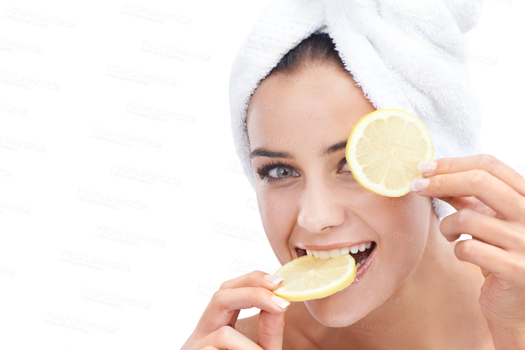 Buy stock photo Woman, skincare and lemon in studio portrait for beauty, cosmetics and natural health or vitamin c benefits. Face of a young model eating fruits with eye dermatology or detox on a white background