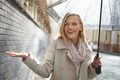 Buy stock photo Woman, umbrella and hand with rain in city, walking and surprise for splash, weather and happy in winter. Person, wow and smile with travel, journey and excited with water on sidewalk in Cape Town