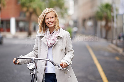 Buy stock photo Shot of a young woman in the street with a bicycle