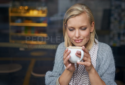 Buy stock photo A young woman sitting in a coffee shop
