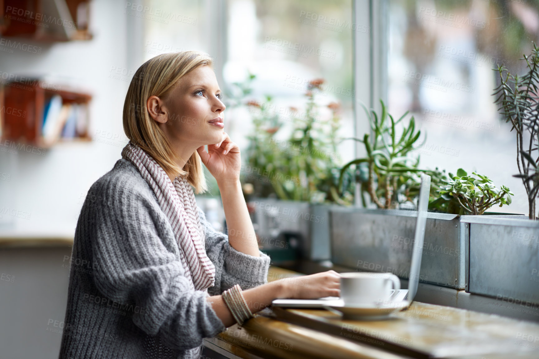 Buy stock photo A young woman sitting in a coffee shop