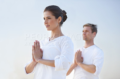 Buy stock photo Couple outdoor, meditation and prayer for zen with blue sky, mindfulness for holistic healing and wellness. Spiritual, aura and chakra balance together for bonding, stress relief and peace in nature
