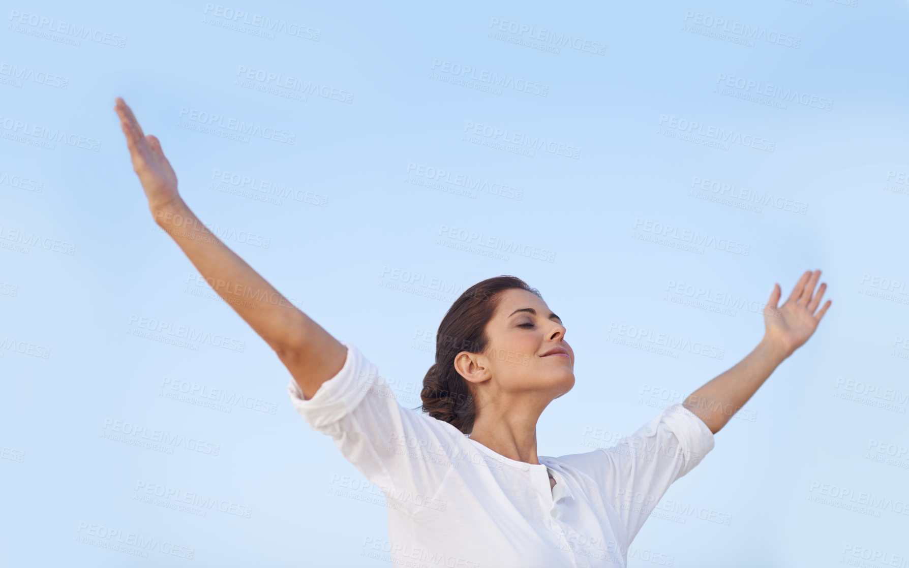 Buy stock photo A young woman standing with her arms outstretched