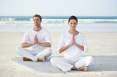 Buy stock photo Lotus, yoga and couple on beach in morning for fitness, exercise and mindfulness with prayer hands. Nature, love and man and woman by ocean for meditation, wellness and healthy body outdoors together