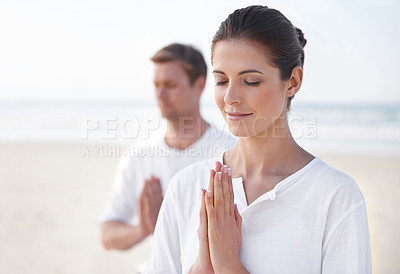 Buy stock photo Praying hands, couple and meditation on beach for zen and wellness with holistic healing outdoor for calm and yoga. Ocean, people and mindfulness together for bonding, peace and spiritual in nature