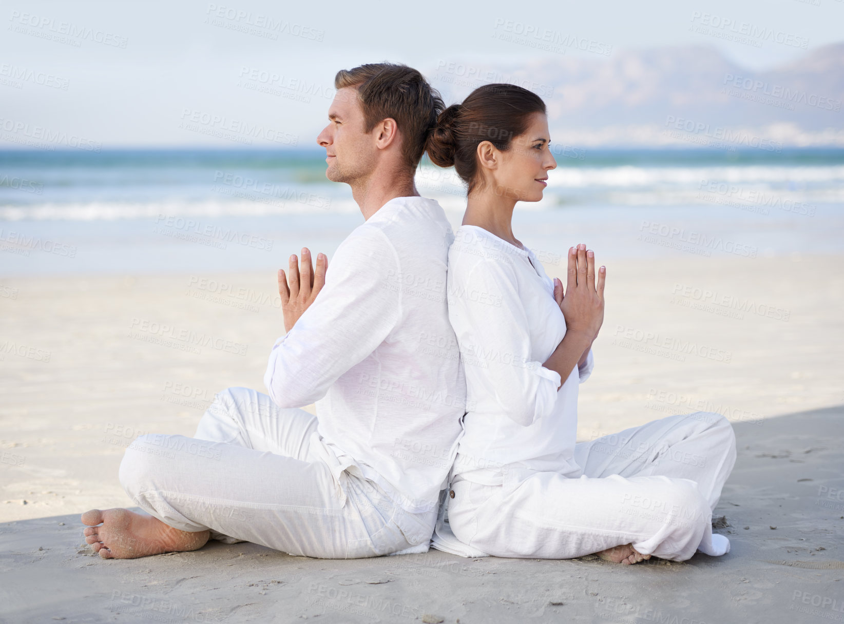 Buy stock photo Couple, yoga and beach with meditation, sitting and peace on sand in morning with mindfulness in summer. Man, woman and outdoor for namaste with spiritual growth, balance or zen by ocean in Cape Town