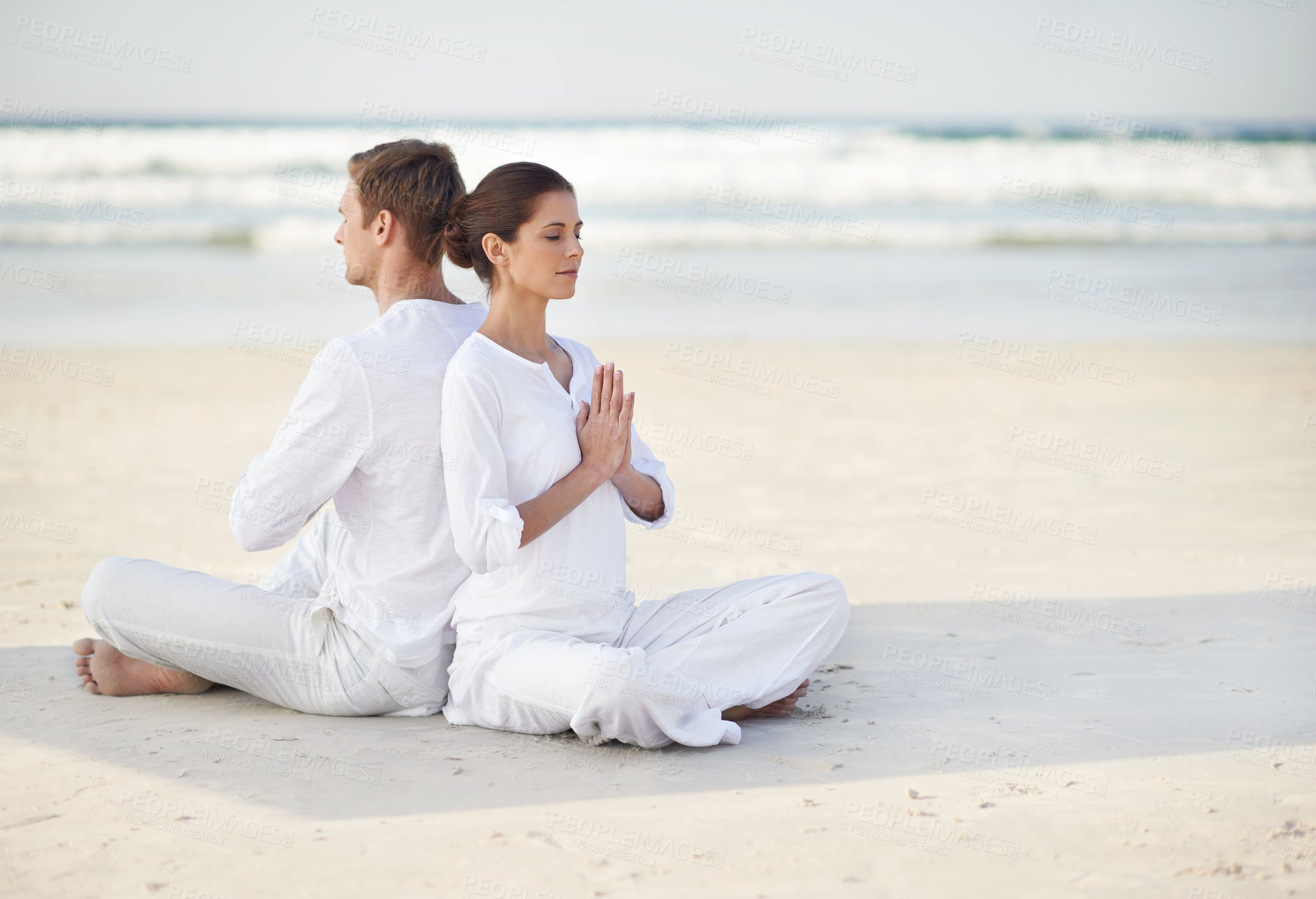 Buy stock photo Couple, yoga and sea with meditation, sitting or waves by sand in morning with mindfulness outdoor. Man, woman and peace for namaste with spiritual growth, balance or zen at beach in Cape Town