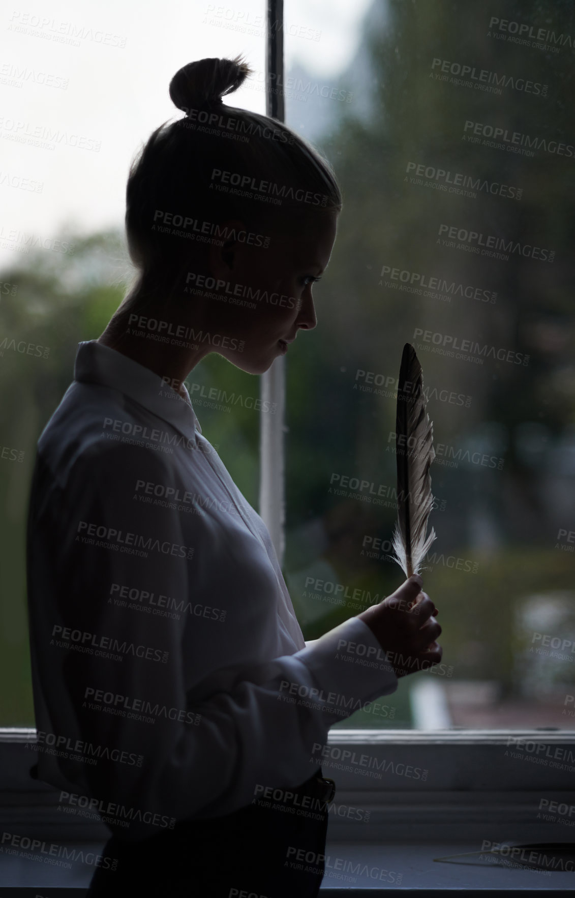 Buy stock photo Woman, feather and window with silhouette, home and room for thinking and contemplation. Model, creative and mindfulness with thoughtful, shadow and decisions with abstract, artistic and idea