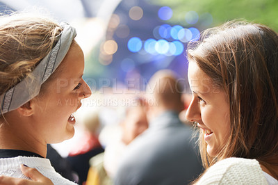 Buy stock photo Happy, friends and women at music festival, concert or party for social life, excited and talking of rave or techno. People, audience or crowd from back at a carnival, event and bokeh on a stage 