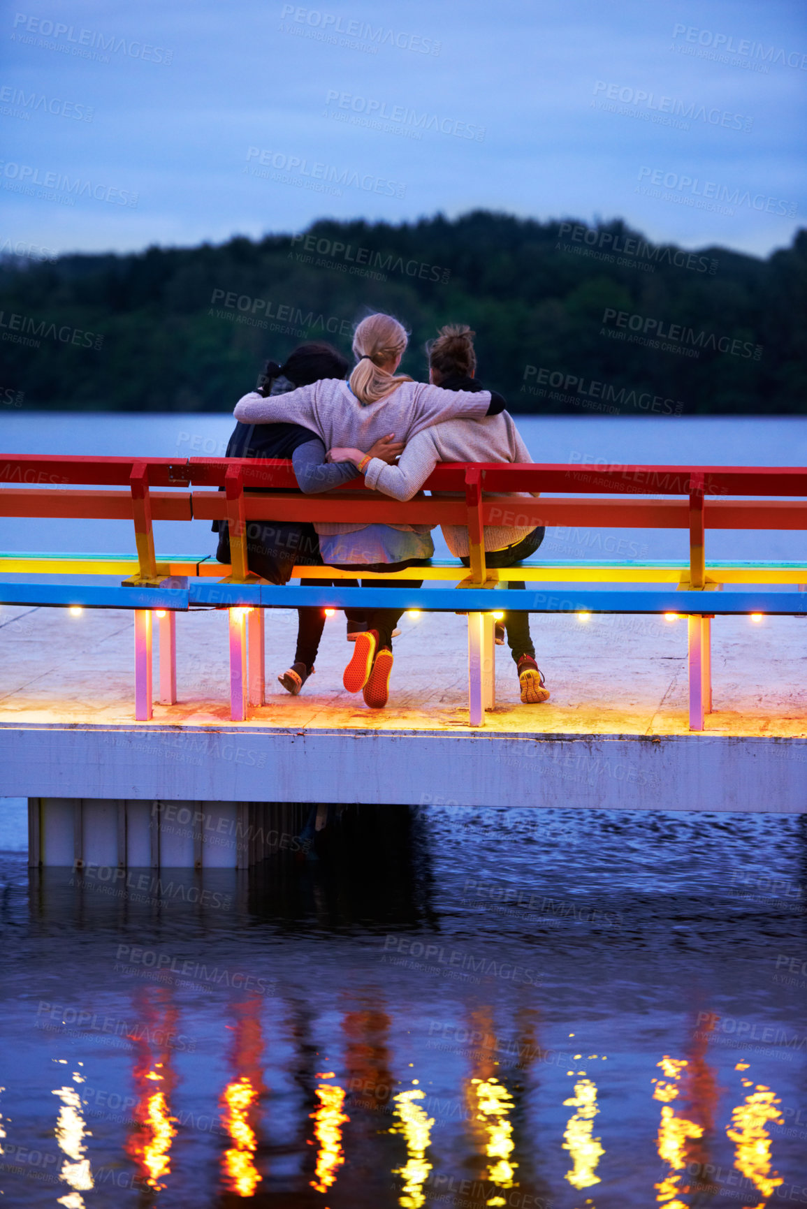 Buy stock photo Lake, bench and back of girl friends watching water in nature on vacation, adventure or holiday. Bonding, care and female friends embracing on wood chair in evening on outdoor weekend trip together.