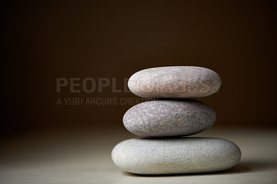 Buy stock photo Pile, studio or stones at spa for healing, massage or wellness treatment therapy for balance. Stack, aromatherapy and rocks for a calm, zen or peace atmosphere at a natural salon on black background