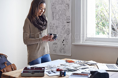 Buy stock photo A young woman working on her portfolio at home