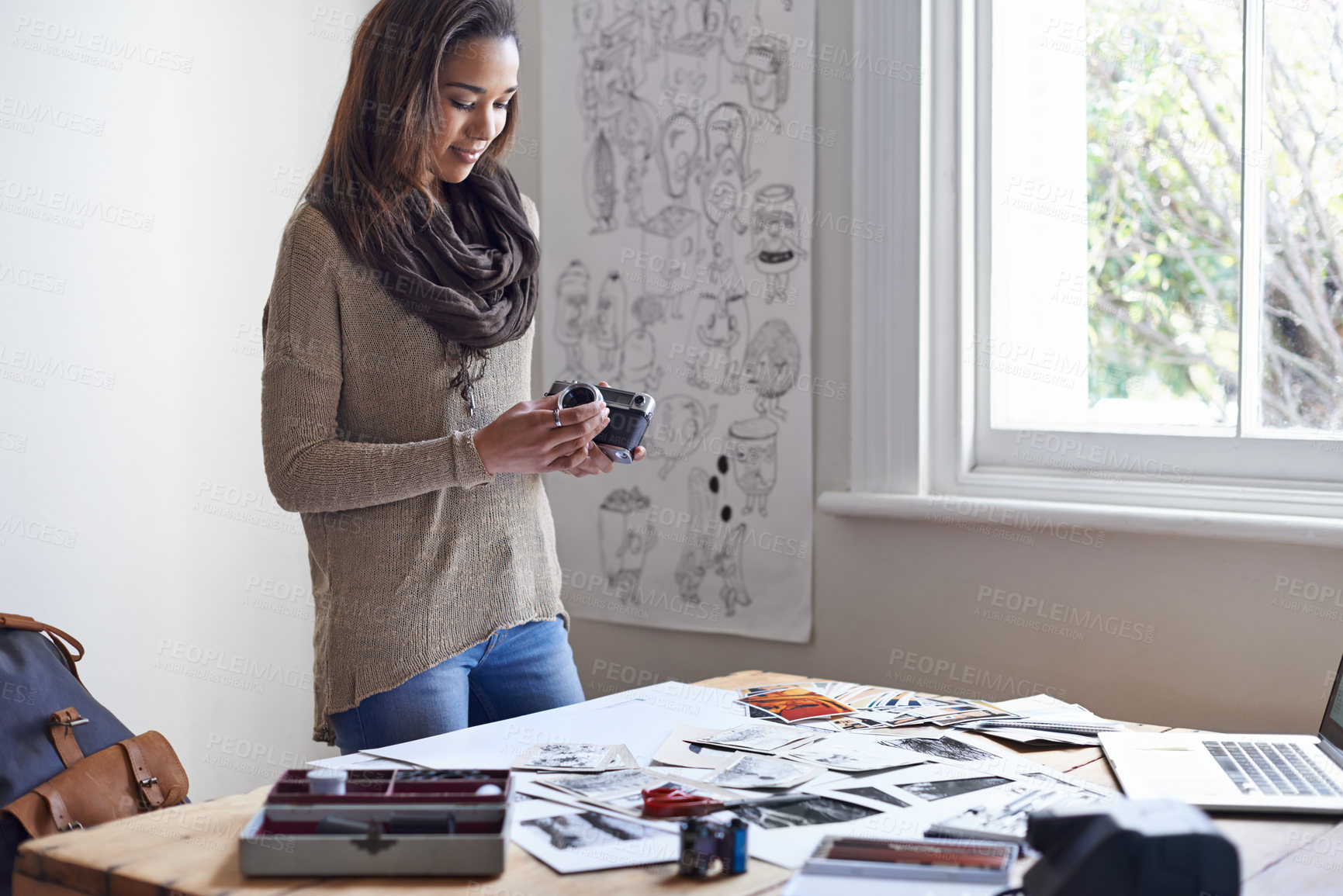 Buy stock photo A young woman working on her portfolio at home