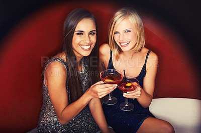 Buy stock photo Two gorgeous young woman enjoying cocktails