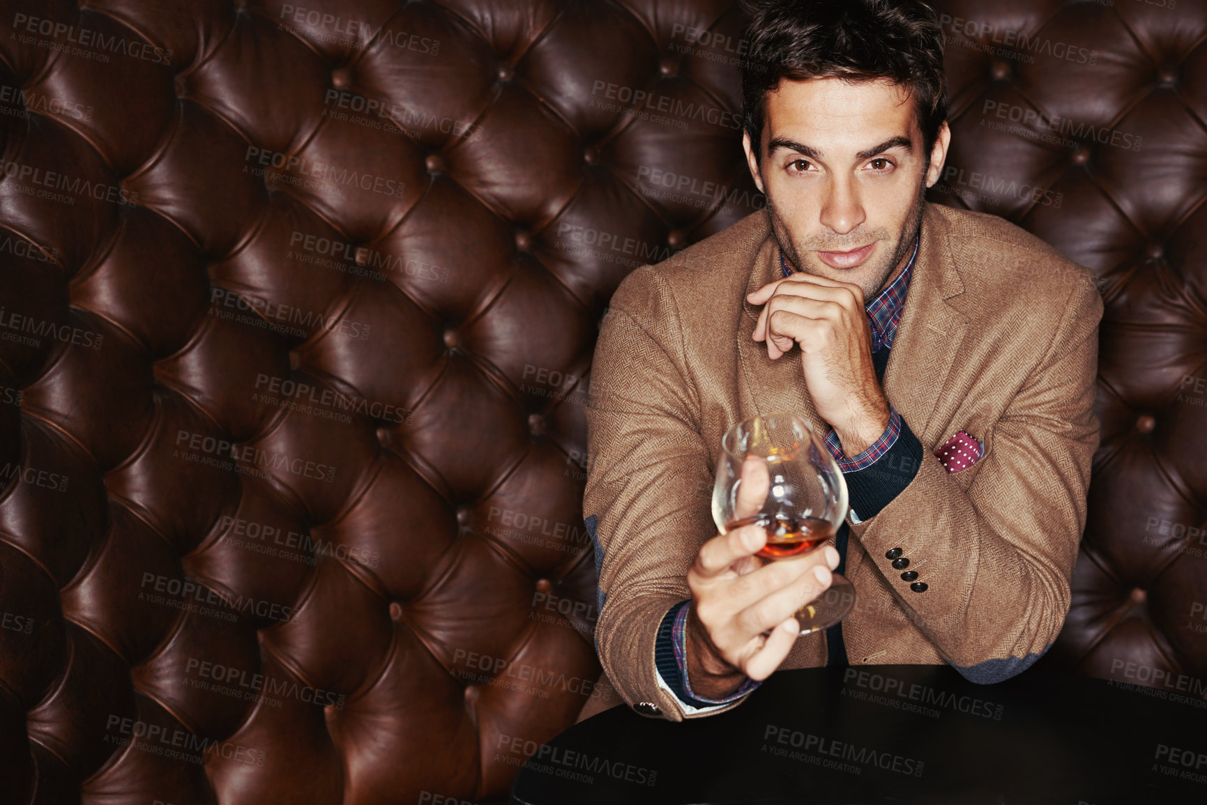 Buy stock photo Portrait of a handsome young man drinking in a club