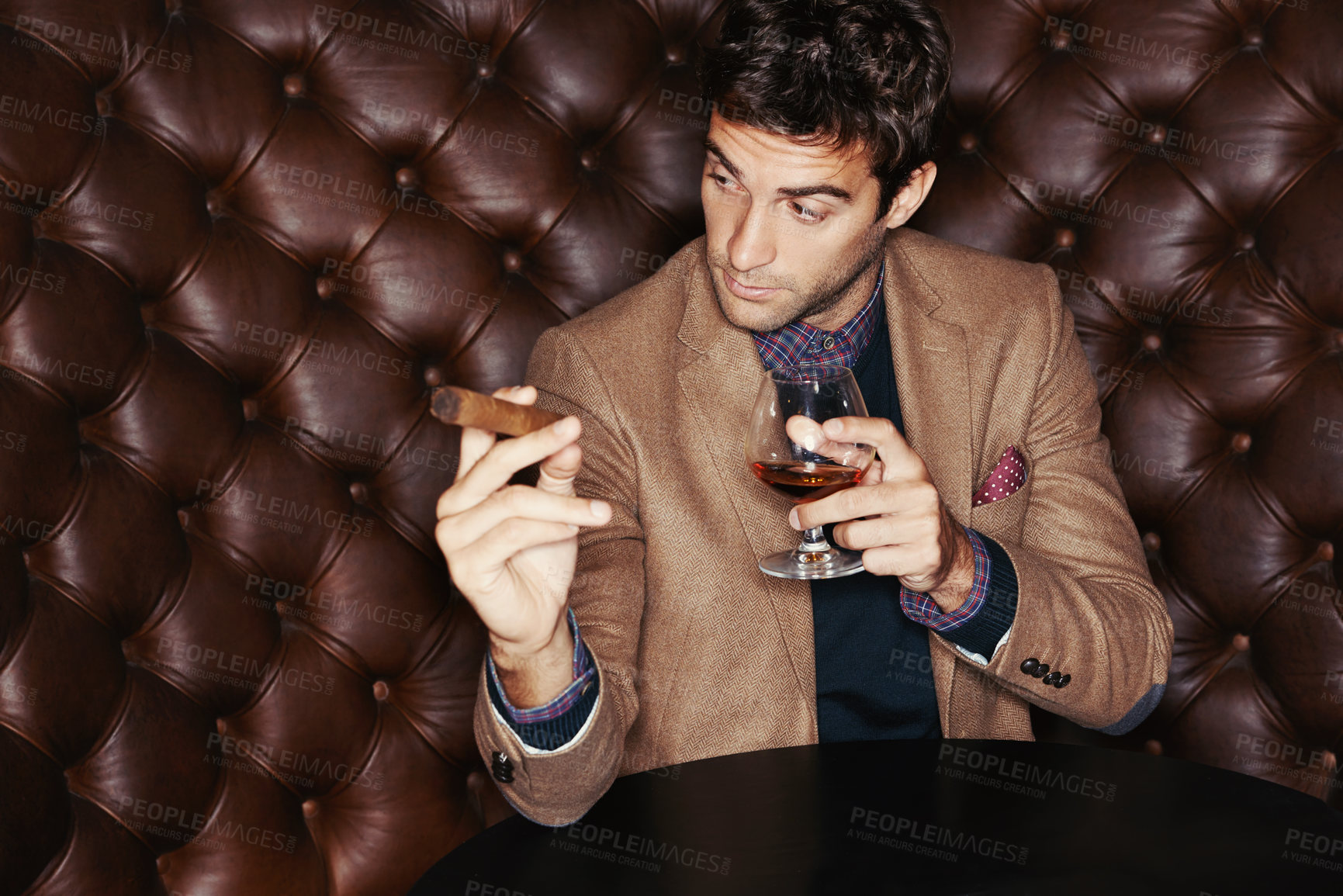 Buy stock photo Cigar, businessman and drinking whiskey at club, fashion and person in a suit with alcohol at vintage bar. Mafia, smoking and serious person with scotch, beverage or brandy in glass for luxury at pub