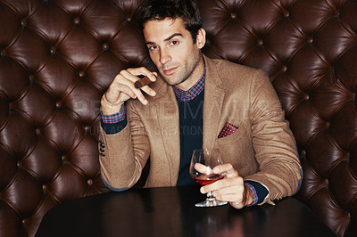 Buy stock photo Portrait, cigar and businessman drinking at club, fashion and person in a suit with alcohol at vintage bar. Face, smoking and serious person with whiskey, scotch and brandy in glass for luxury at pub