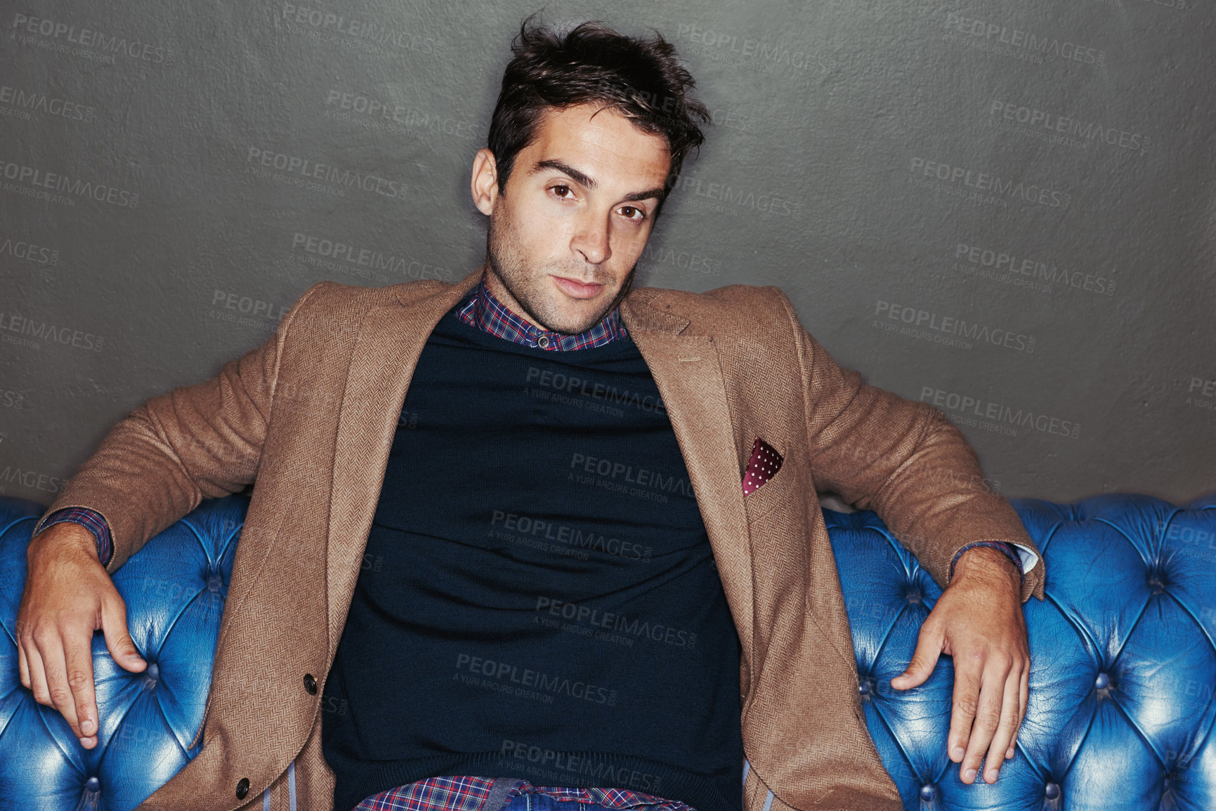 Buy stock photo Portrait of a young man sitting on a leather couch