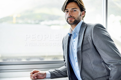 Buy stock photo Business man, entrepreneur and serious by window in portrait, confident and professional in office. Male person, employee and pride for career at startup company, professional and expert at workplace