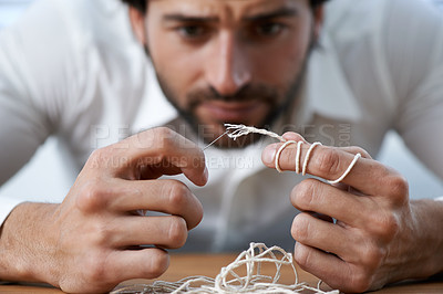 Buy stock photo String, thread and man with eye of needle for stitching, sewing and needlework in fashion industry. Struggle, concentration and hands of person with tools for material, textile and tailor business