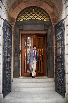 Buy stock photo A view of a businessman leaving work through an ornate doorway
