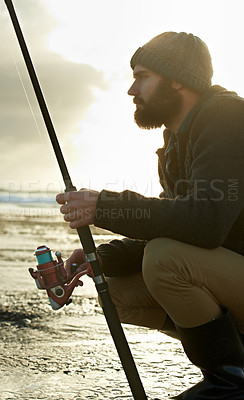 Buy stock photo Beach, ocean and man with fishing rod in water in the morning in summer outdoor for hobby or leisure. Sea, fisherman and person with pole in nature, serious or angler thinking of recreation with reel