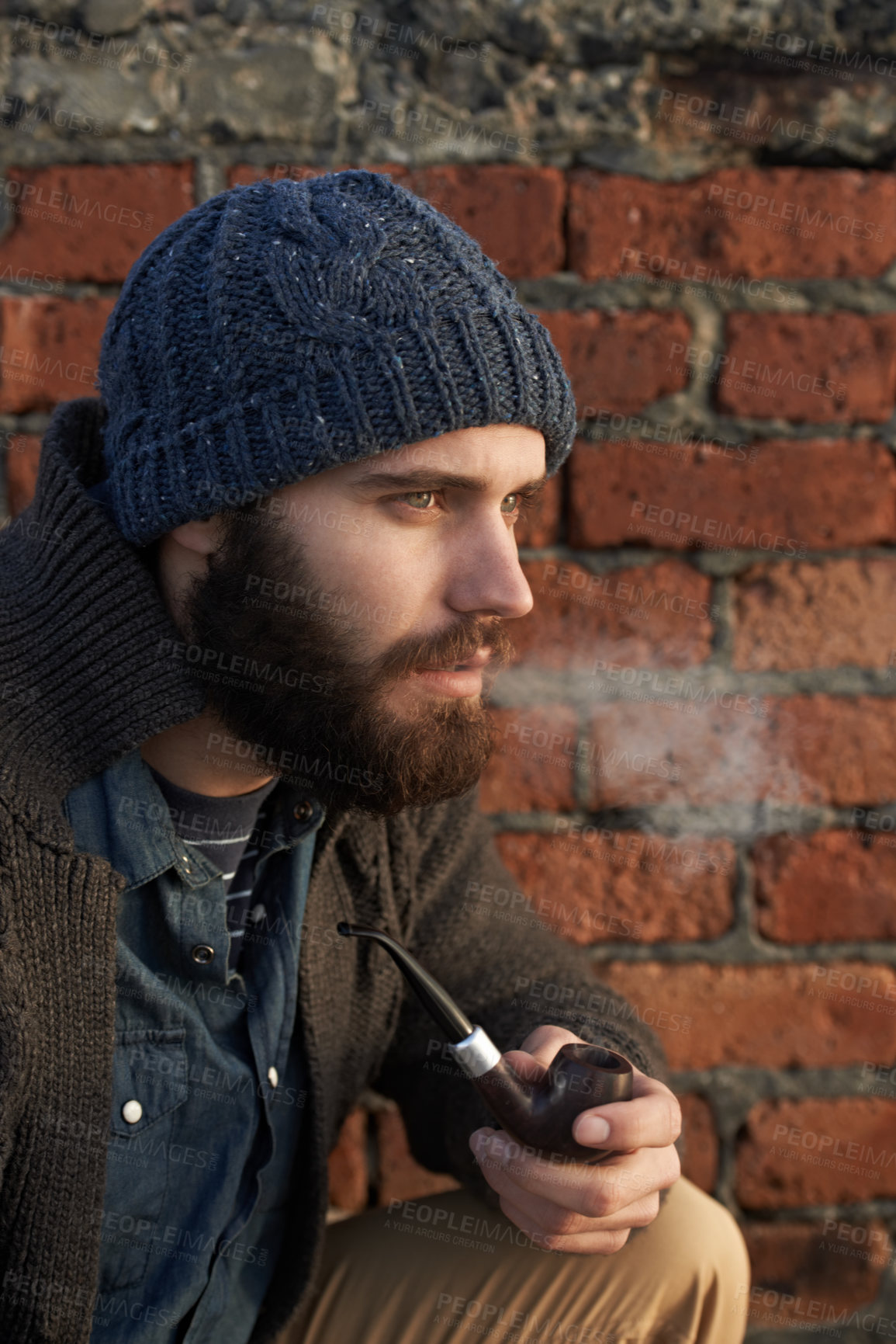 Buy stock photo Face, winter and pipe smoke with man outdoor on wall background for fashion, style or clothing. Morning, tobacco or habit and young person with beanie smoking in cold weather season to relax
