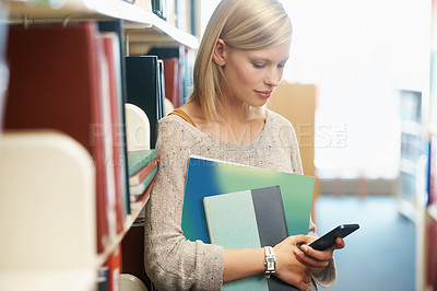Buy stock photo Woman, books in library and smartphone, education and research on university website for studying and knowledge. Student on campus, using phone for email or ebook, information and reading online