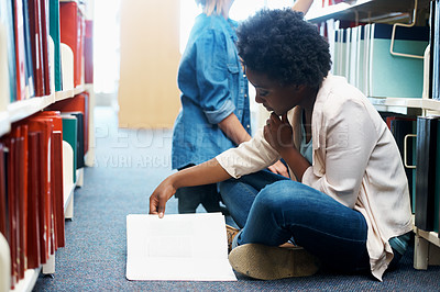 Buy stock photo Woman, library and reading book on floor for education or english project for university, scholarship or college. Female person, campus and academic exam in USA for research, lesson or literature