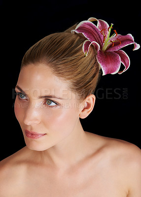 Buy stock photo Hair, flower and beauty of woman, thinking and skincare isolated on a black studio background. Natural, floral makeup and hairstyle of model in cosmetics, salon and lily for organic facial treatment