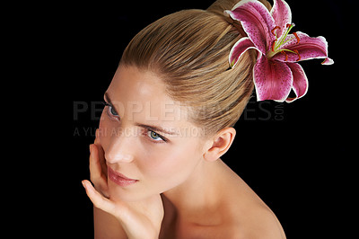 Buy stock photo Hair care, flower and woman touch skin, thinking and beauty isolated on a black studio background. Natural, floral makeup and hand of model in cosmetics, salon and lily for organic facial treatment