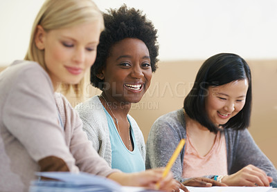 Buy stock photo Shot of female university students sitting in an exam room