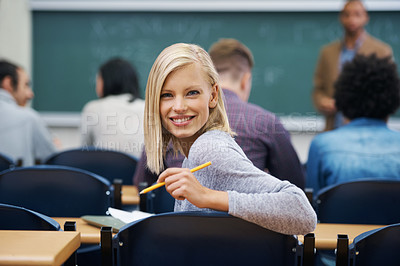 Buy stock photo University student, portrait and smile at classroom desk in London for english lecture, education or scholarship. Female person, face and pen at academy with professor for teaching, lesson or exam