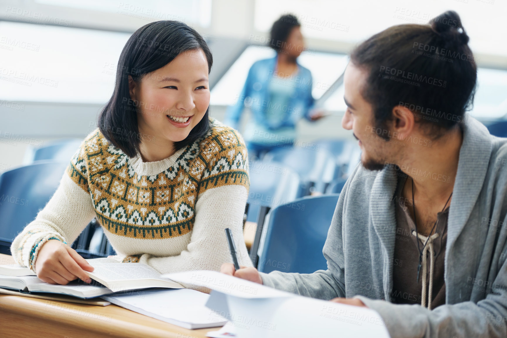 Buy stock photo Conversation, university and students in classroom for studying with textbook for test or exam. Discussion, writing and young people working on college assignment together in lecture hall at academy