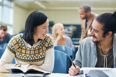 Buy stock photo Discussion, college and students in classroom for studying with text book for test or exam. Conversation, writing and young people working on university assignment together in lecture hall at academy