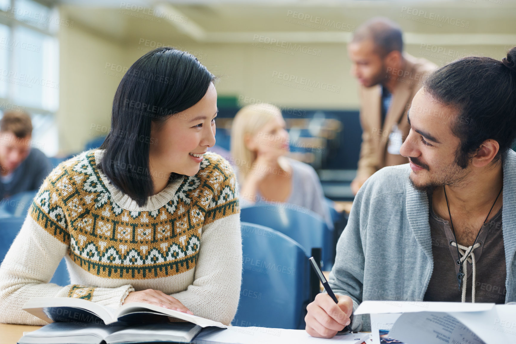 Buy stock photo Discussion, college and students in classroom for studying with text book for test or exam. Conversation, writing and young people working on university assignment together in lecture hall at academy