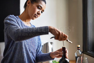 Buy stock photo Woman, opening wine and bottle for dinner, evening meal with corkscrew and preparing to drink for enjoyment and nutrition. Alcoholic beverage, tools or equipment with cooking for dining in kitchen