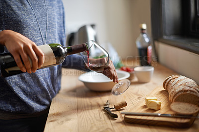 Buy stock photo Hands, pouring red wine and home for dinner, relax for peace and person with drink in kitchen. Alcohol, glass and bottle with refreshment, hydration with beverage and read to chill in apartment