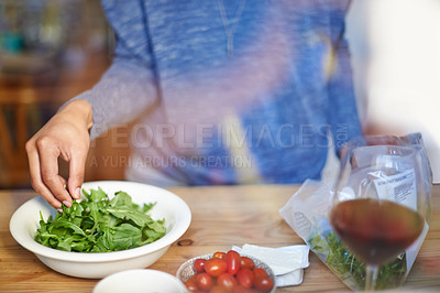 Buy stock photo Person, cooking and prepare salad on table in kitchen closeup with wine in home for dinner. Tomato, lettuce and hands with healthy food in bowl to meal prep on counter for nutrition and diet in house